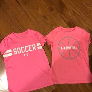 Pair of pink girls’ UA Heatgear sports tees